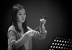 A female percussionist who was also the first female to be employed by the band.