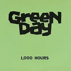 Two lines of text, "Green Day" and "1,000 Hours", in black ink against a light green background