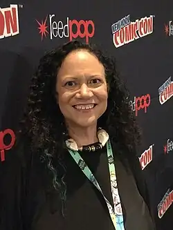 Randall standing in front of a New York Comic Con-branded backdrop