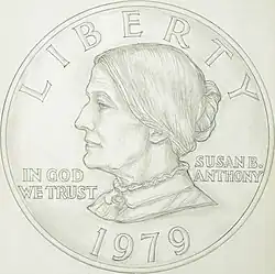 A drawing of one side of a coin, depicting the profile of a woman