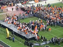 Clemson players take the stage to receive the trophy.
