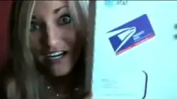 Video screengrab where iJustine is showing a large boxed package with the labels from the United States Postal Service and AT&T.
