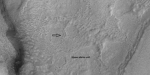 Brain terrain is forming from the breakdown of upper plains unit, as seen by HiRISE under HiWish program Arrow points to a place where fractures are forming that will turn into brain terrain.