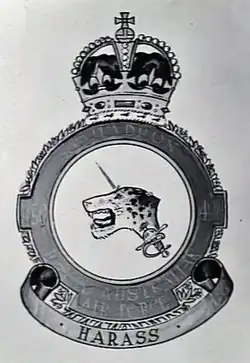 Drawing of a Royal Australian Air Force crest depicting a jaguar's head pierced by a rapier; the motto beneath reads "Harass"