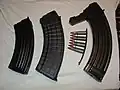 Magazines for three different 7.62×39mm rifles and a stripper clip loaded with ammunition