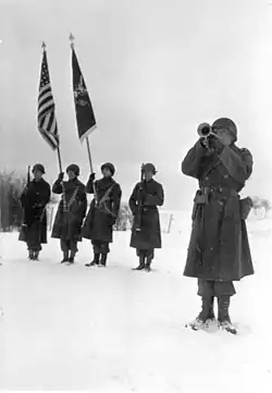 "Taps" at memorial ceremony for men of Company C, 9th Armored Engineer Battalion. Who were killed during siege of Bastogne, Belgium.