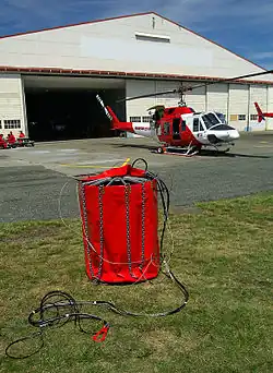A canvas bucket being used as a helicopter bucket
