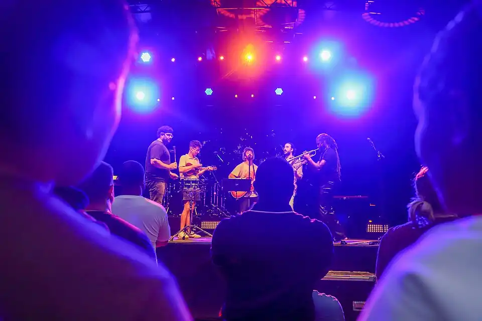 AJR performing "World's Smallest Violin" with Arnetta Johnson (far right) and Chris Berry (far left)