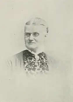 B&W portrait photo of a gray-haired woman with her hair in an up-do