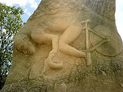 A rock, encarved with an image of a man on a bicycle