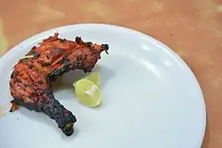 A portion of a tandoori chicken, at a restaurant in India.