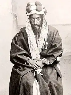 A photograph of Abdul Rahman bin Faisal seated and dressed in traditional Arabian clothing