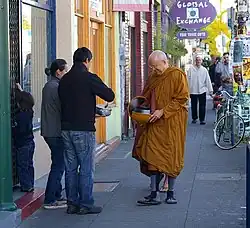 Ṭhānissaro, an American monk, practicing piṇḍacāra by receiving piṇḍapāta in Portland, Oregon, United States