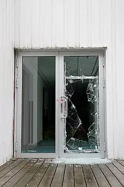 A broken glass door.