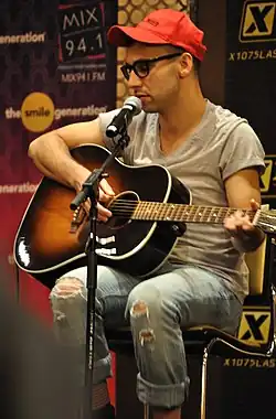 Jack Antonoff playing a guitar