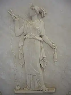 Atropos cutting the thread of life. Modern Greek low relief.