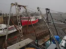 Photo of boat in water next to a dock
