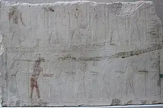 Relief showing two rows of people with hieroglyphic signs