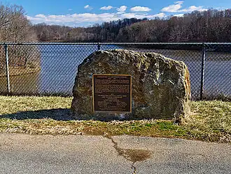 A photograph of an onsite dedication stone to wilderness activist Bernard Frank, after whom the lake is named in honor.
