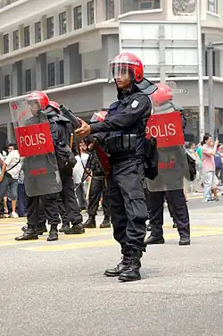 A member of the Malaysia's Federal Reserve Unit prepares to disperse protesters during the Bersih Rally 2.0.
