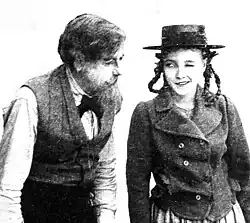 Young woman in period dress winking at camera