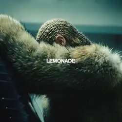 Beyonce wearing cornrows and a brown fur coat, leaning against a car with her arm obscuring her face; the title “Lemonade” is overlaid in white text in the center of the image.