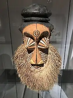 Mulwalwa mask; 19th or early 20th century; painted wood and raffia; Ethnological Museum of Berlin. This mask embodies a powerful nature spirit. As there are no holes through which a performer could see, it was probably mounted on a wall at an initiation camp, signaling that the initiation was almost complete.