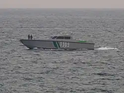 Small grey-and-green boat