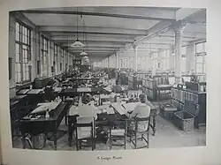 Female clerks attending to savings ledgers