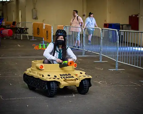A competitor in a Power Wheels racing event at Open Sauce