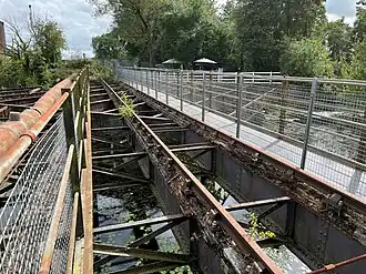 An open girder bridge, allowing you to see the water in the canal underneath