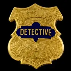 CDP badge - features number (for patrol officers) or rank in the middle. Pictured here is a detective's badge