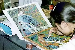 Adding frit with dropper after sintering cloisons. Upon completion the piece will be fired, then ground (repeating as necessary) then polished and electroplated