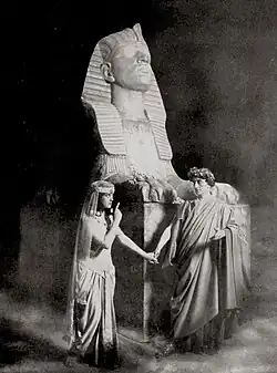 Stage photograph showing actor as Julius Caesar and actress as Cleopatra in Egyptian setting