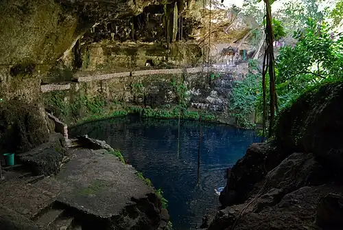 Huge open-air cave partially filled with water