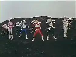 Screenshot of five costumed men in front of their motorcycles