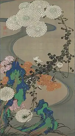 Chrysanthemums by a stream with rocks