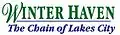 Winter Haven in a green serif font on top except for a cursive W, "The Chain of Lakes City" on bottom in an italicized sans serif font