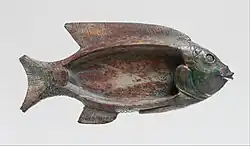 Cosmetic dish in the shape of a tilapia fish; 1479–1425&nbsp;BC; glazed steatite; 8.6&nbsp;cm ×&nbsp;18.1&nbsp;cm (3.4&nbsp;in ×&nbsp;7.1&nbsp;in); Metropolitan Museum of Art