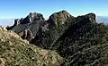 Northwest aspect from Lost Mine Trail. Crown's west peak centered, east peak (true summit) to left.