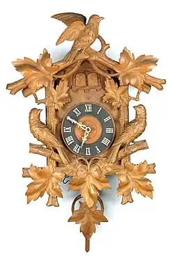 A carved cuckoo and quail clock, c. 1880 (Deutsches Uhrenmuseum, Inv. 07–2653)