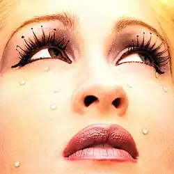 Close-up of Cyndi Lauper's face. There are tears running down her eyes.