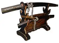 An Edo-period daishō koshirae on its stand. The long-sword is generally stored above the wakizashi, curving downwards. When hung for display, the tip points to the right.