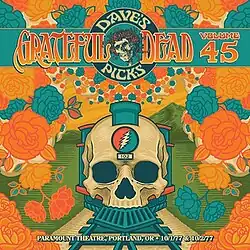 A train with a front end that looks like a skull, with roses coming out of the smokestack