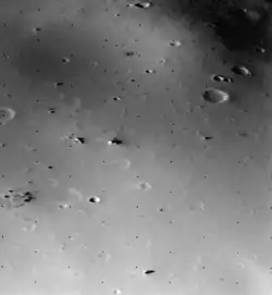 The surface of Deimos, a moon of Mars, is covered by a layer of regolith estimated to be 50&nbsp;m (160&nbsp;ft) thick. Viking 2 orbiter image is from a height of 30&nbsp;km (19&nbsp;mi).