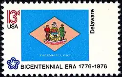 The Delaware state flag as depicted in the 1976 bicentennial postage stamp series.