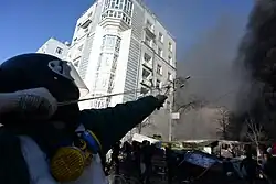 Helmeted combatant fires a slingshot during clashes on February 18, 2014, in Kyiv, Ukraine