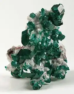 Dioptase crystals on calcite, a classic Tsumeb specimen. Size: 8.2 x 5.8 x 5.5&nbsp;cm