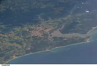 ISS image from 2005 showing the city of Joinville (center) with the Baía da Babitonga, Araquari (center below), to the right São Francisco do Sul with the coast of the South Atlantic.