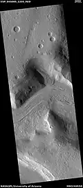 Wide view of flow moving down valley, as seen by HiRISE under HiWish program Location is Ismenius Lacus quadrangle.